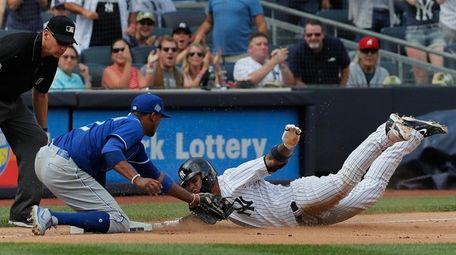 Yankees' Gleyber Torres, right, is tagged out by