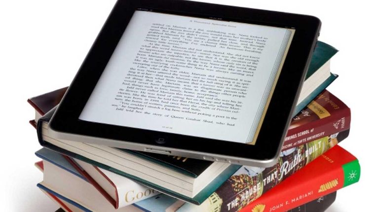 An ipad on top of books.