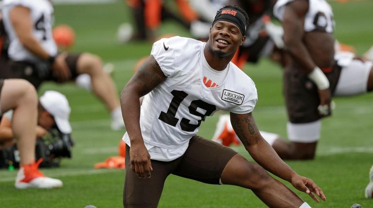 Browns wide receiver Corey Coleman stretches during training