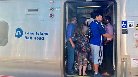 Commuters wait for the doors to close on