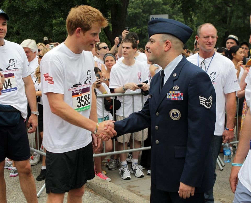 Prince Harry greets a member of the United