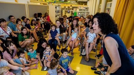 Children's librarian Lesley Siegel entertains kids during Sing