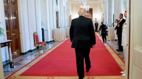 President Donald Trump departs a ceremony.