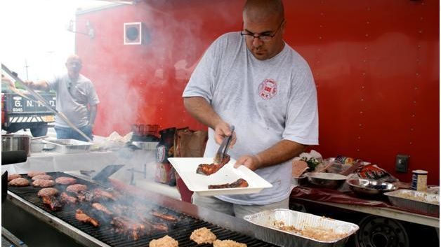 Syosset Fire District Commissioner Frank Vasile preparing ribs
