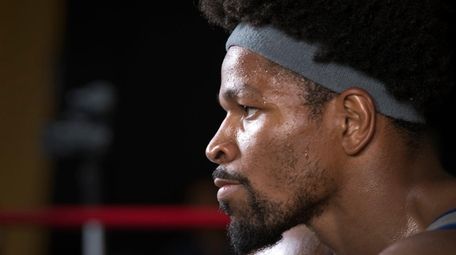 Shawn Porter looks into a mirror during a