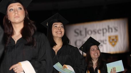 St. Joseph's College graduates walk during the academic