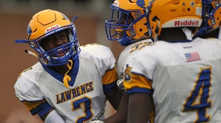 Keaton Goldsby #2 of Lawrence, left, gets mobbed