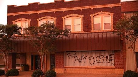 Businesses are boarded up on Wednesday before the