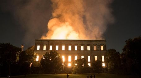 People watch as flames engulf the 200-year-old National