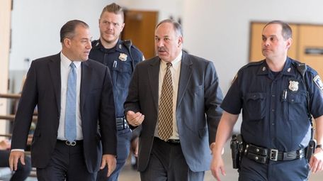Suffolk County Court Judge Jeffrey Arlen Spinner, center,