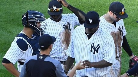 Yankees manager Aaron Boone takes the ball from