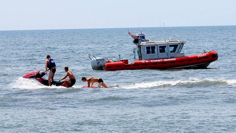 Life guards search for missing swimmers in Long