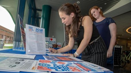 Gabriella Cordi, left, and Courtney Schroder sign a