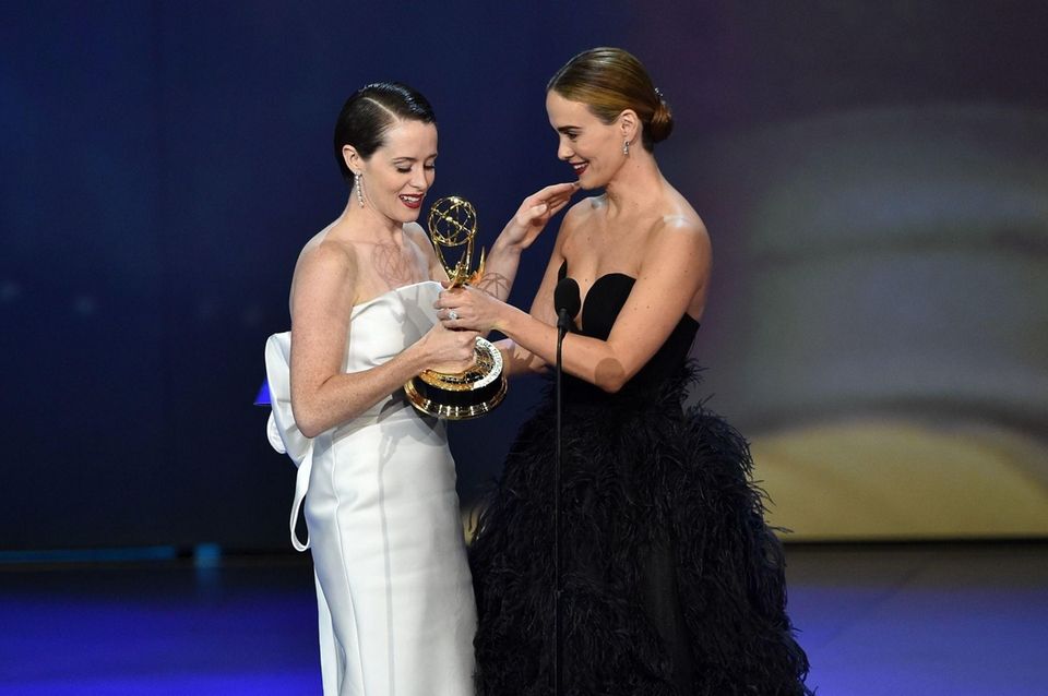 Claire Foy left, receives the award for lead