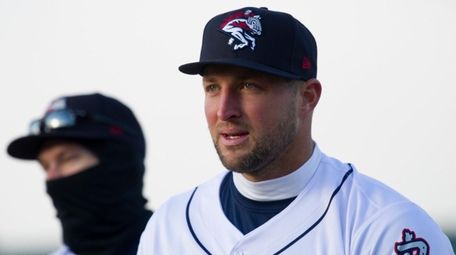 Tim Tebow warms up on the field before