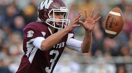 Quinn O'Hara #3, Whitman quarterback, takes a snap