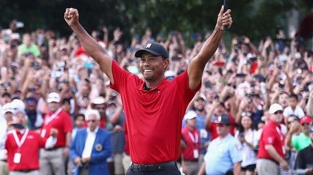 Tiger Woods celebrates making a par on the