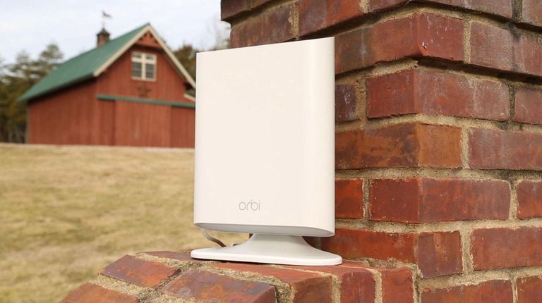 Netgear's weather-resistant Orbi Outdoor Satellite, along with an
