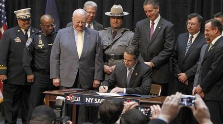 Gov. Andrew M. Cuomo signs the NY Safe