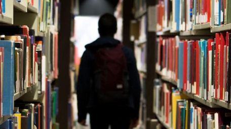 Stock image of a student in a library.