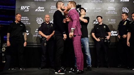UFC lightweight champion Khabib Nurmagomedov, left, faces off