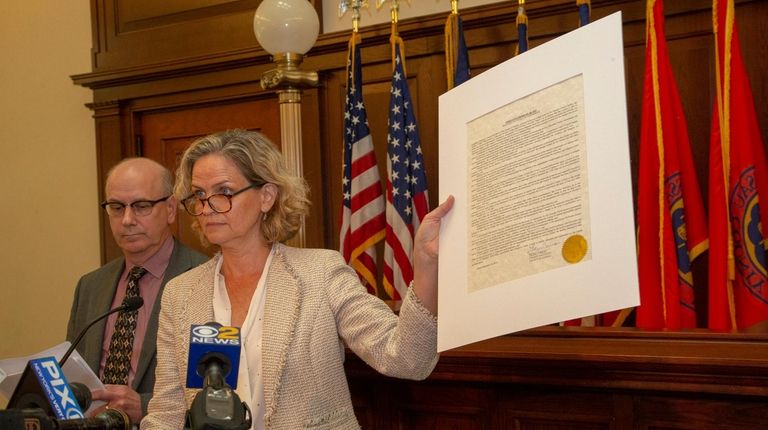 Nassau County Executive Laura Curran signs an executive