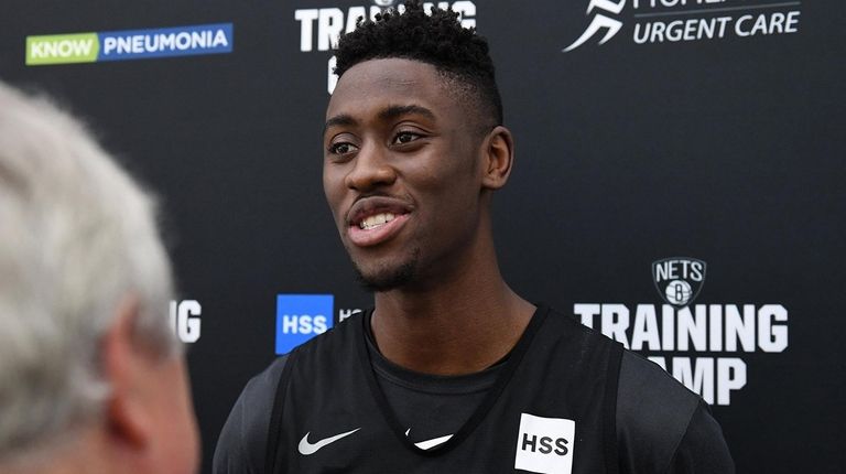Nets guard Caris LeVert talks to the media