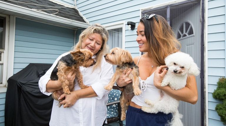 Veronica Pizarro and her daughter, Katherina, hold their