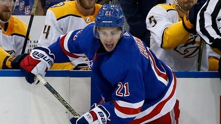 The Rangers' Brett Howden plays the puck during