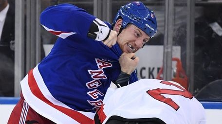 New York Rangers left wing Cody McLeod fights