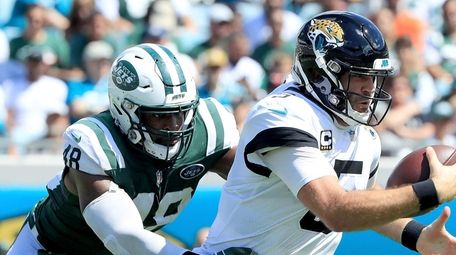 Jordan Jenkins of the Jets attempts to tackle