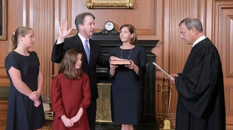Chief Justice John Roberts, right, administers the Constitutional