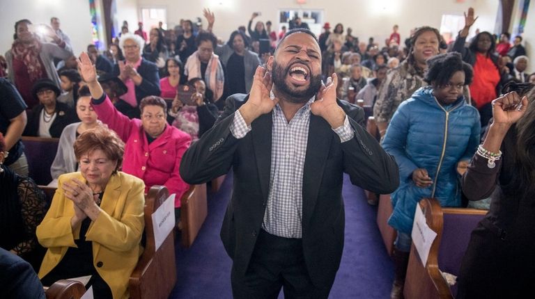 Aaron K. Marsh leads a gospel group at