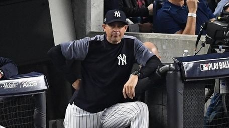 Yankees manager Aaron Boone looks on from the