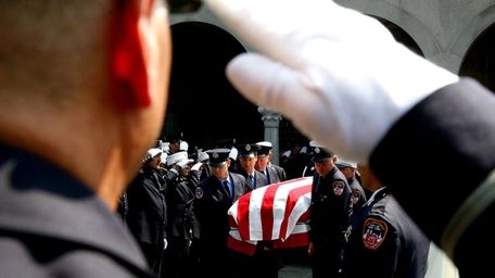 Firefighters carry the coffin of Vincent J. Albanese,