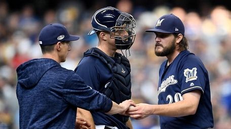 Wade Miley of the Brewers is pulled by