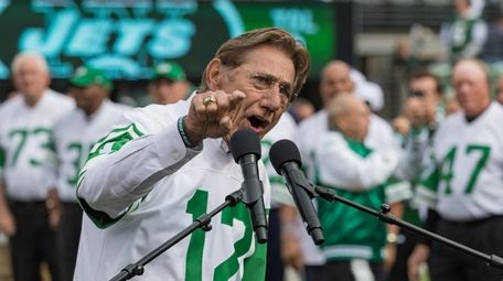 Joe Namath speaks, with members of the team