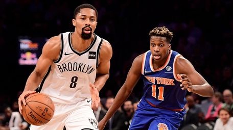 The Nets' Spencer Dinwiddie is defended by the