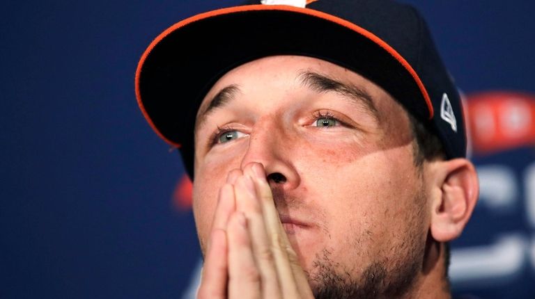 Astros third baseman Alex Bregman listens to a