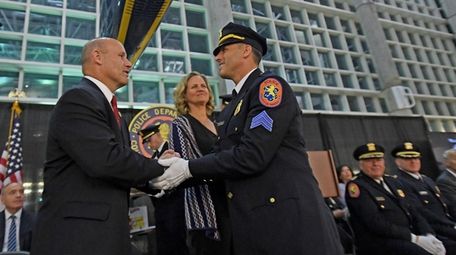 Jason A. Sepulveda, right, shakes hands with Nassau