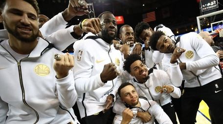 The Golden State Warriors celebrate after receiving their