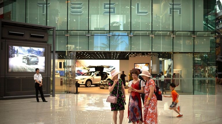 Women outside of a Tesla showroom at an
