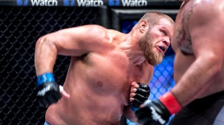 Josh Copeland, left, hits Shawn Johnson during a