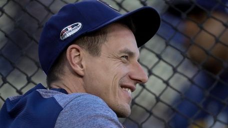 Brewers manager Craig Counsell watches batting practice before