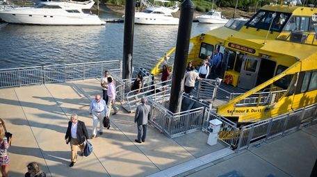 Commuters disembark at the Glen Cove Ferry Terminal