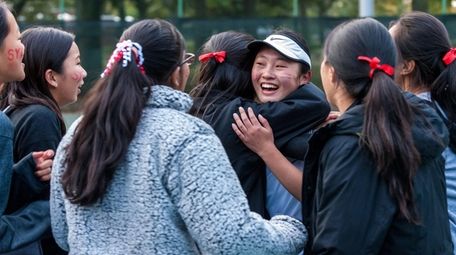 Syosset's Sarah Wong celebrates with teammates after winning