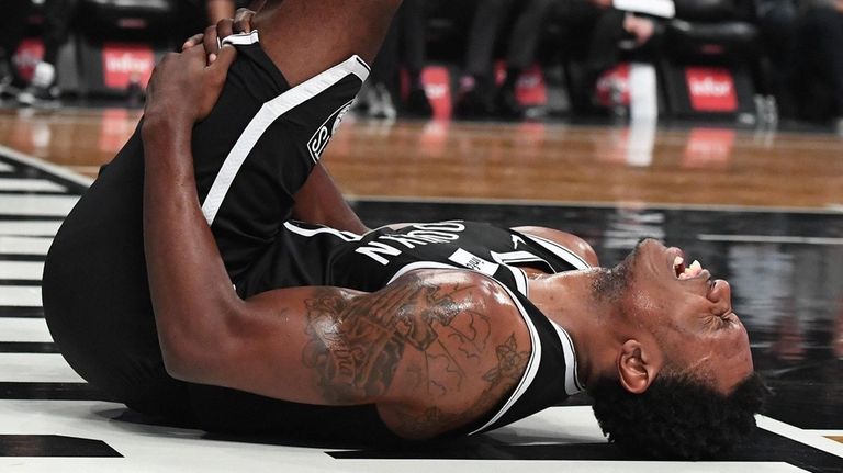 Nets guard Treveon Graham grimaces in pain in