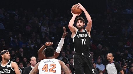 Nets forward Joe Harris sinks a three-point shot