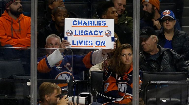 A fan holds a banner in reference to