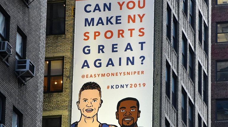 A billboard in midtown Manhattan shows likenesses of